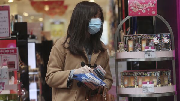 Cô gái đeo khẩu trang trong cửa hiệu mỹ phẩm. - Sputnik Việt Nam