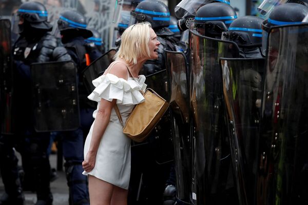 Người phụ nữ đối đầu với các sĩ quan cảnh sát trong cuộc biểu tình chống hạn chế của Pháp ở Paris  - Sputnik Việt Nam