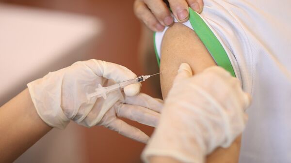 Nhân viên y tế tiêm vaccine phòng COVID-19 cho người dân quận Hoàn Kiếm, chiều 15/9/2021. - Sputnik Việt Nam