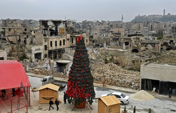 Công nhân dựng cây thông Noel tại Quảng trường Al-Khatab ở Aleppo bị tàn phá, Syria. - Sputnik Việt Nam