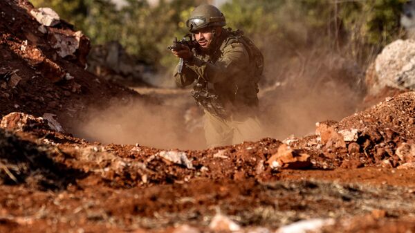 Một binh sĩ quân đội Israel tiến lên trong cuộc tập trận tại một vị trí ở vùng Galilee phía bắc Israel gần biên giới với Lebanon - Sputnik Việt Nam