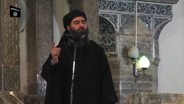 This July 5, 2014 photo shows an image grab taken from a propaganda video released by al-Furqan Media allegedly showing the leader of the Islamic State (IS) jihadist group, Abu Bakr al-Baghdadi, aka Caliph Ibrahim, adressing Muslim worshippers at a mosque in the militant-held northern Iraqi city of Mosul - Sputnik Việt Nam