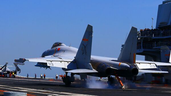 This photo taken on April 24, 2018 shows a J15 fighter jet landing on China's sole operational aircraft carrier, the Liaoning, during a drill at sea - Sputnik Việt Nam